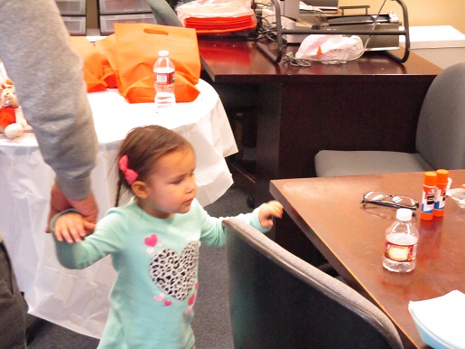 A little girl at the Braille table